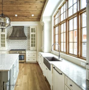 Montrose Metal Range Hoods in a kitchen with white cabinets