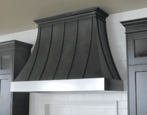 antique steel patina with stainless details on custom range hood by raw urth designs