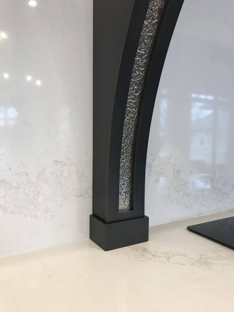 corbel on marble countertop with polished chrome details and hammered texture