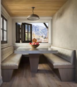 the classic, elegant burnished pewter slab edge countertop with a mountain side in view outside the window
