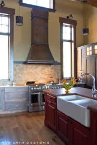 Sanctuary Design features our rustic Breckenridge range hood for high ceilings in Rustic Iron finish.