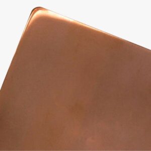 A close-up of the corner of the Polished Copper baking sheet with rounded edges, set against a plain white background.