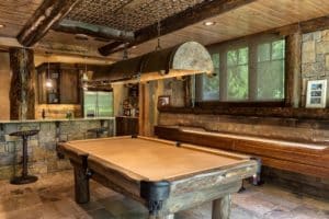 Recreation Room with pool and shuffleboard tables and a fully stocked bar. All made of wood and stone.