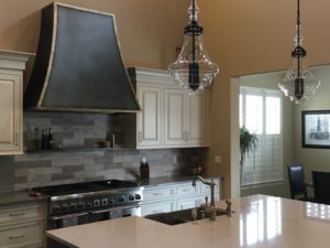 custom dove creek decorative kitchen exhaust hood in aged steel dark to contrast white cabinets
