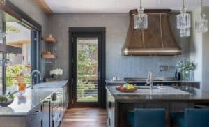 Mary Jane Metal Range Hood in a kitchen with blue walls and modern cabinets and fixtures