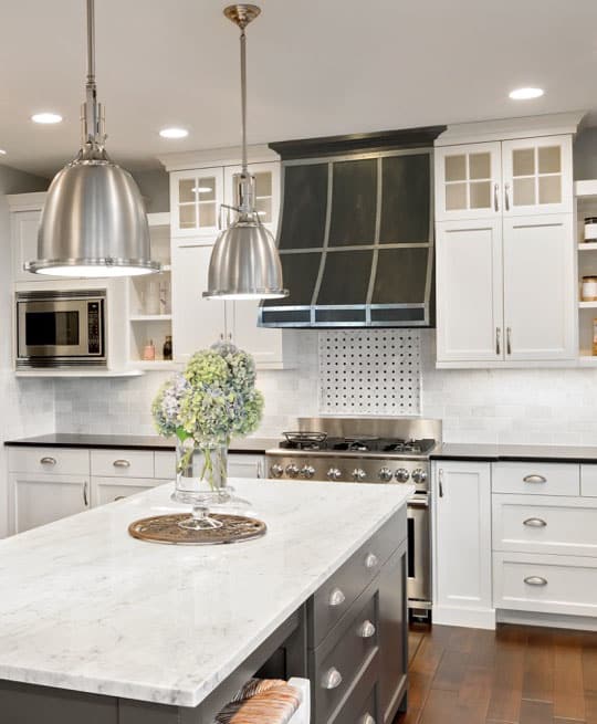 white kitchen with tight to cabinet hood vent in aged Zinc finish