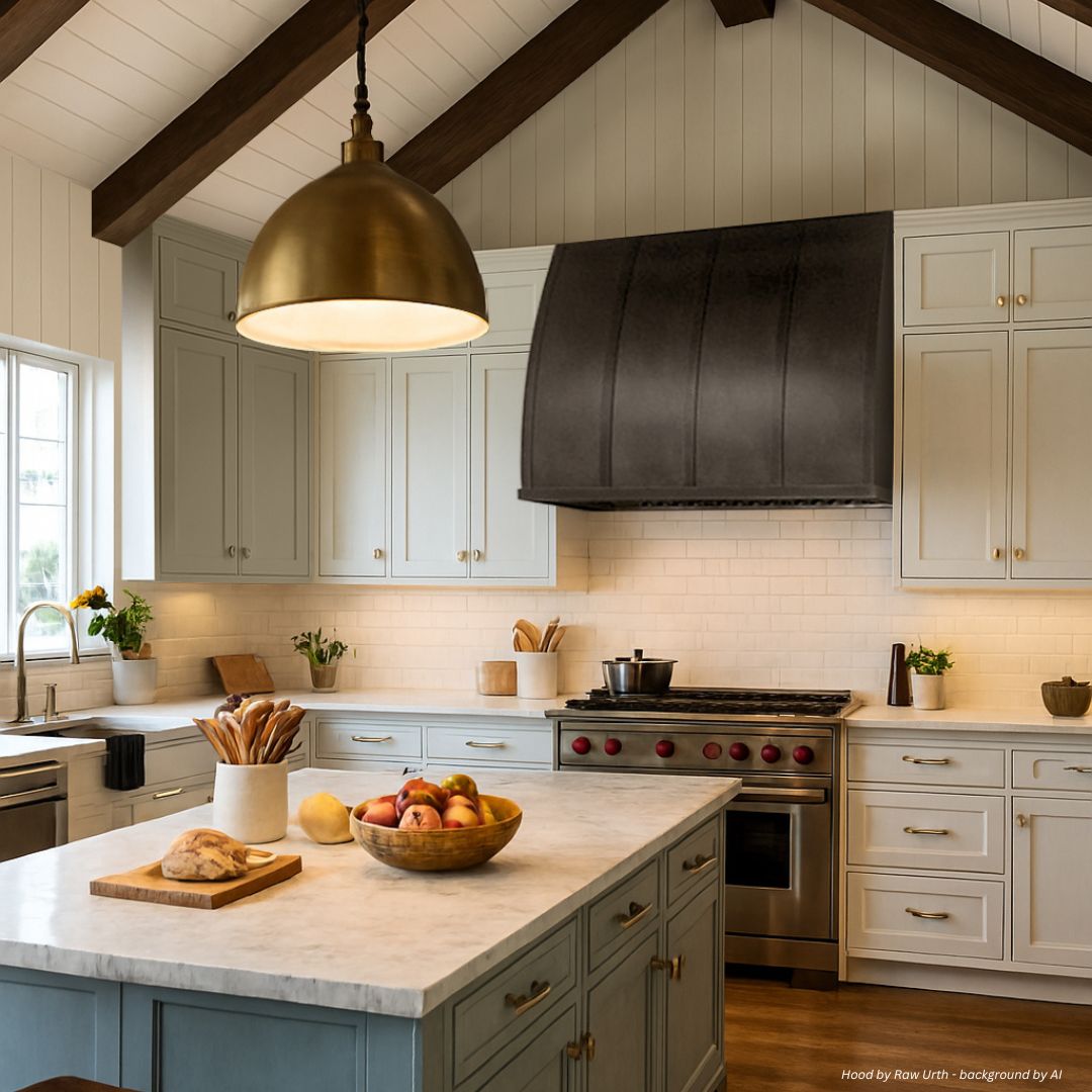 aspen-refined-gallery2 √ The aspen-refined-gallery2 features a modern kitchen with light cabinets, a striking black range hood, marble countertops, an island with fruit and bread, brass pendant lighting, exposed wooden beams, and a window for natural light.