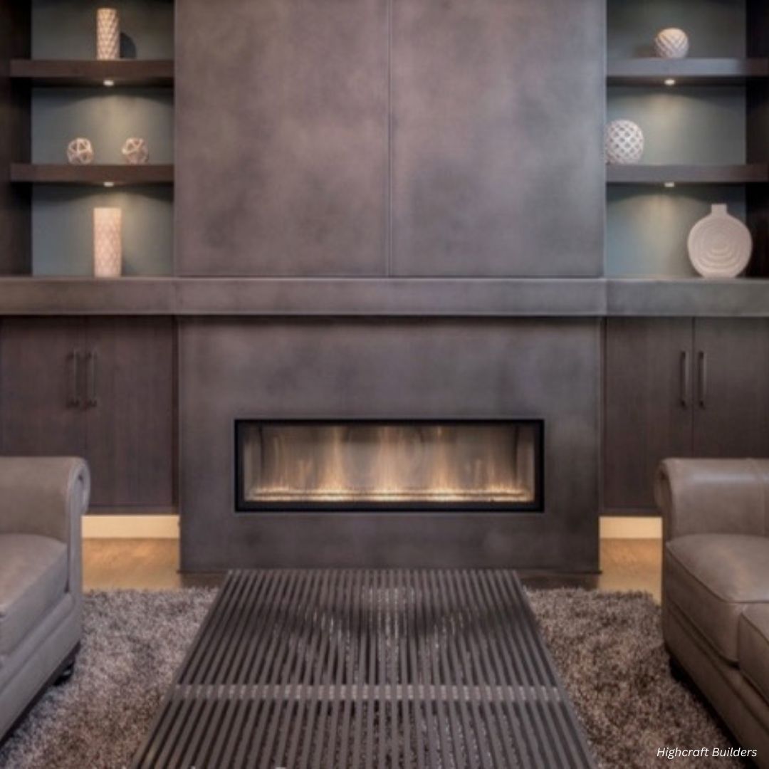 Cladding Gallery 3 Modern living room with Cladding Gallery 3 lit fireplace, featuring dark wood cabinetry, decorative vases, and two gray sofas. A textured rug and a metal coffee table enhance the cozy, contemporary atmosphere.