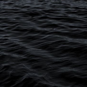50 The 50 features a dark, rippling water surface with subtle waves under low light, crafting a moody and mysterious atmosphere.