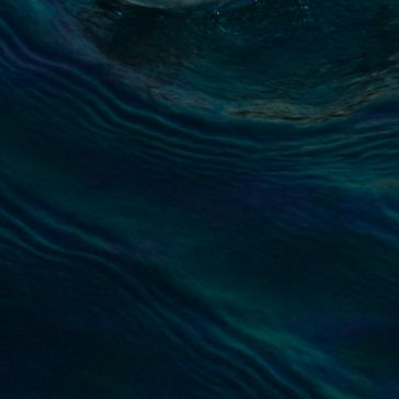 83 features dark blue water with gentle, wavy ripples and subtle light reflections, creating a serene and mysterious atmosphere.
