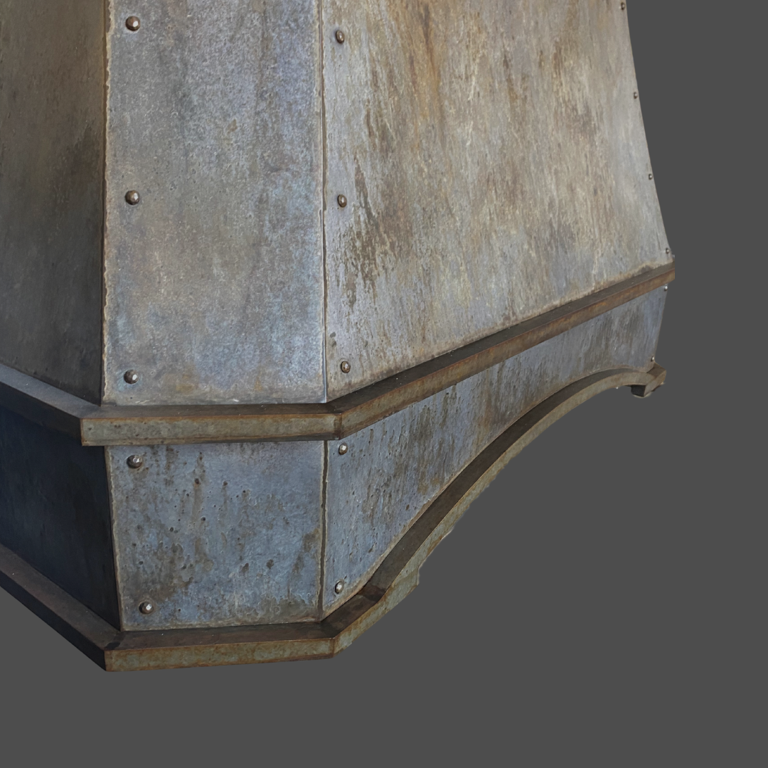 Close-up view of Agate 1, a weathered metal structure with visible rivets and a curved edge, featuring a rustic aged patina set against a plain gray background.