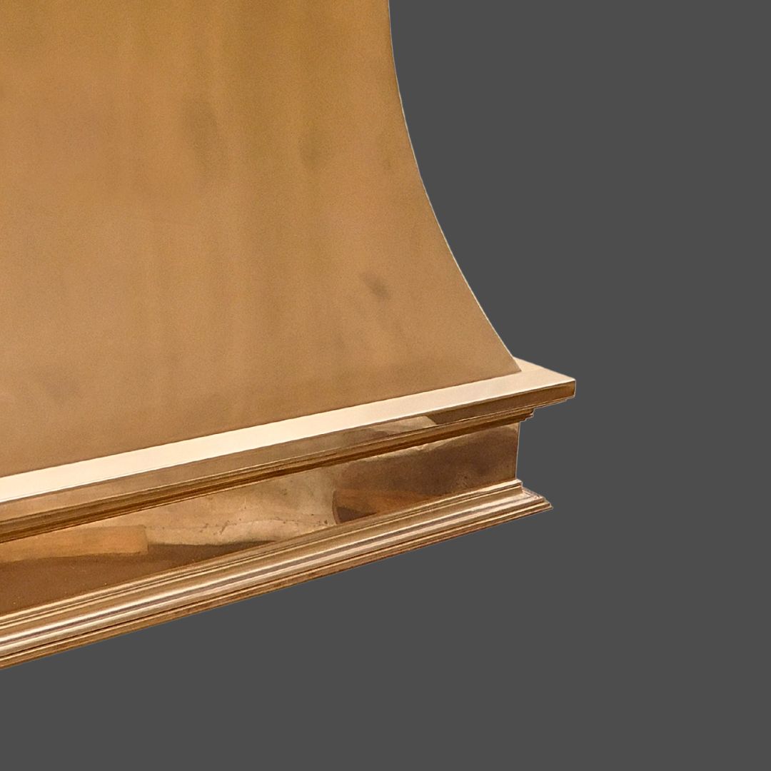 A close-up of Bronze Polished 1, featuring a shiny bronze surface with smooth curves and a rectangular base, set against a plain, dark gray background.