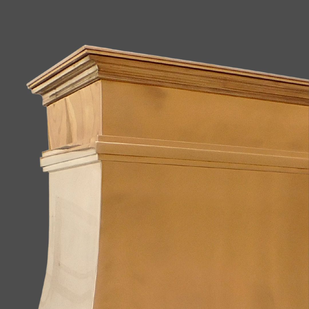 A close-up of the upper corner of the Bronze Polished 2 cabinet, featuring a brown finish and decorative crown molding, set against a plain gray background.