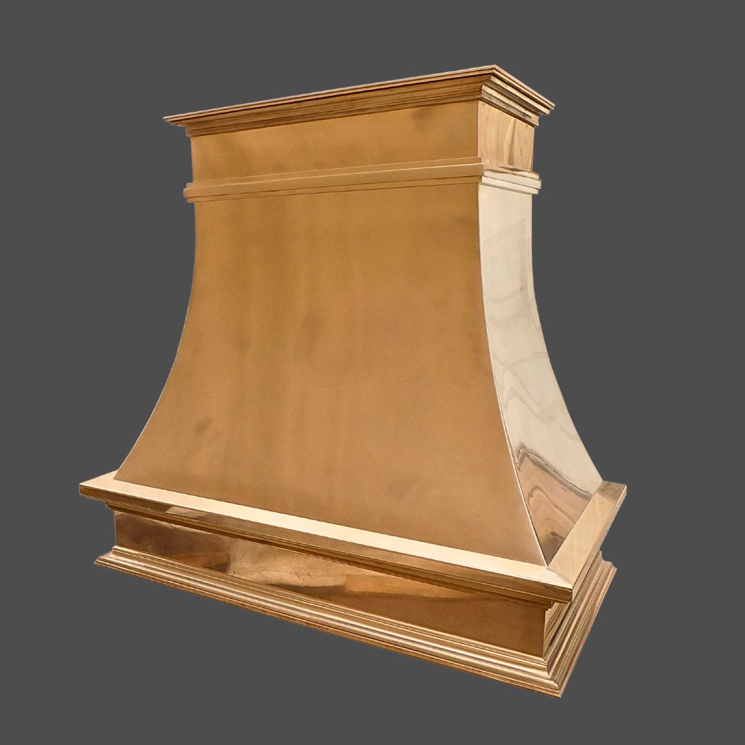 The Bronze Polished 3 is a metallic gold kitchen range hood with a wide, flared base and tapered top, shown against a plain gray background.
