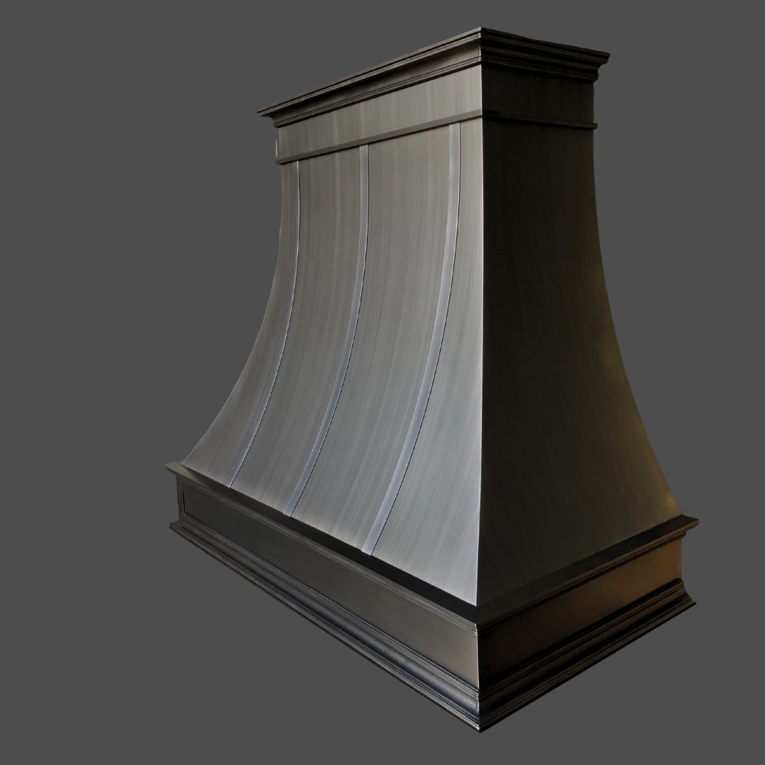 Brushed 1 The Brushed 1 is a large, curved metal kitchen range hood featuring a brushed finish, decorative trim on the top and bottom edges, and a smooth, sloping surface, displayed against a plain gray background.