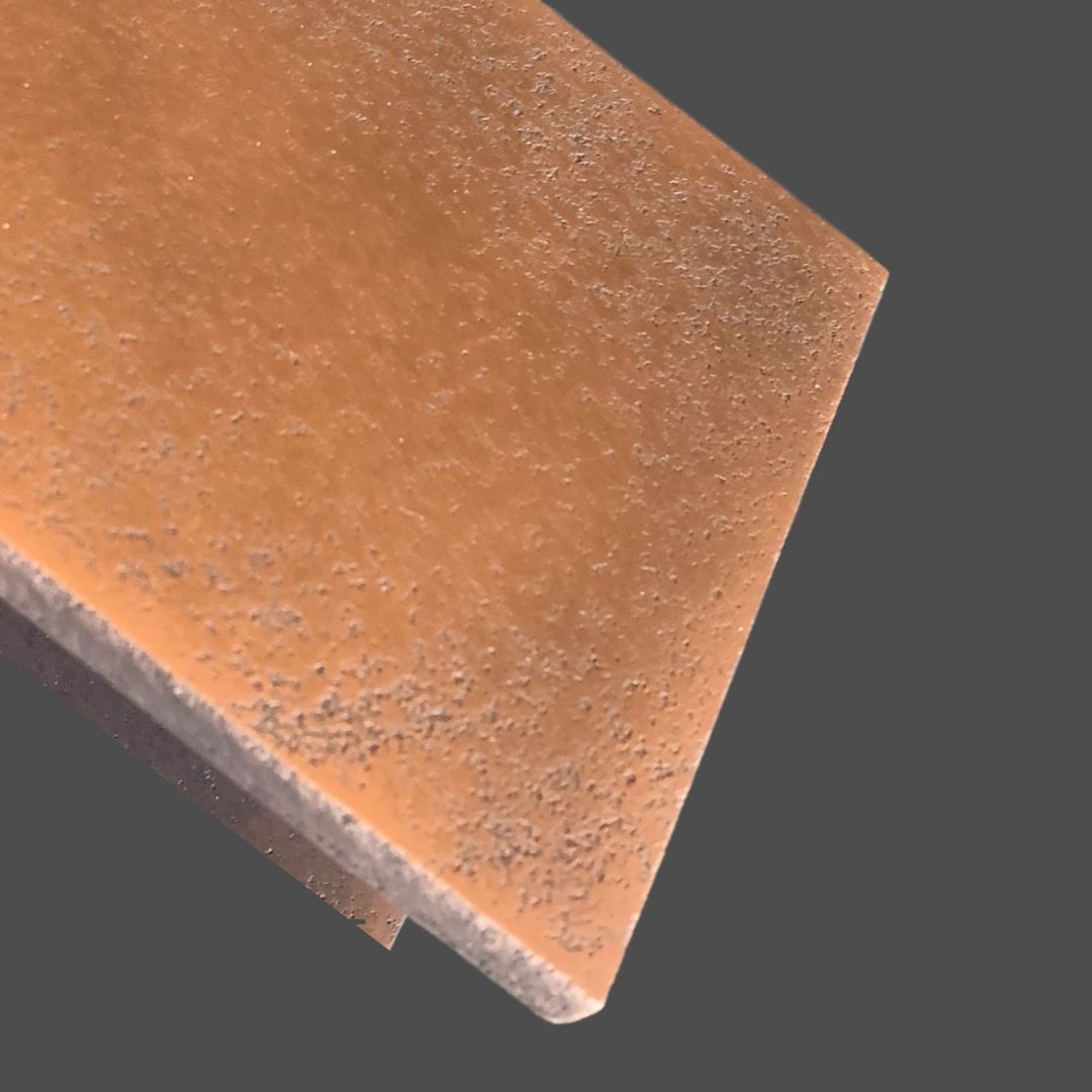 Copper Cast 1 A close-up view of Copper Cast 1, a rectangular brown textured product, displayed against a plain gray background.