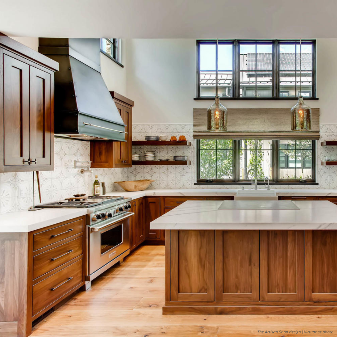 Creede gallery2 The Creede gallery2 features wooden cabinets, a spacious island, white countertops, patterned backsplash, stainless steel stove, open shelves, pendant lighting, and tall windows for abundant natural light.