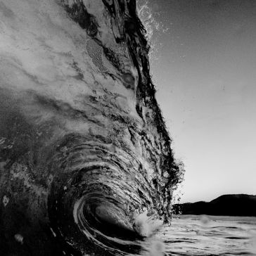 Dark Antique 5 The Dark Antique 5 features a striking black and white photo of a large ocean wave curling dramatically with splashing water and distant hill silhouettes beneath a clear sky.