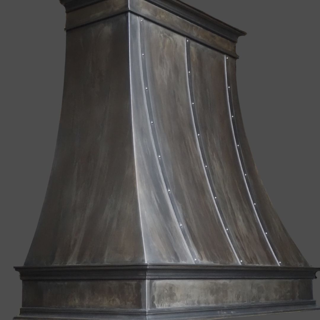 Dark Washed 2 The Dark Washed 2 is a dark, metallic kitchen range hood with a curved, flared shape and vertical riveted seams, displayed against a plain dark background.
