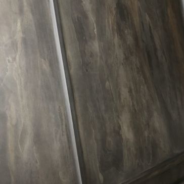 Dark Washed 6375 Close-up of the Dark Washed 6375 surface showing a marbled grayish-brown texture with a vertical seam. Soft lighting emphasizes its color and texture variations.