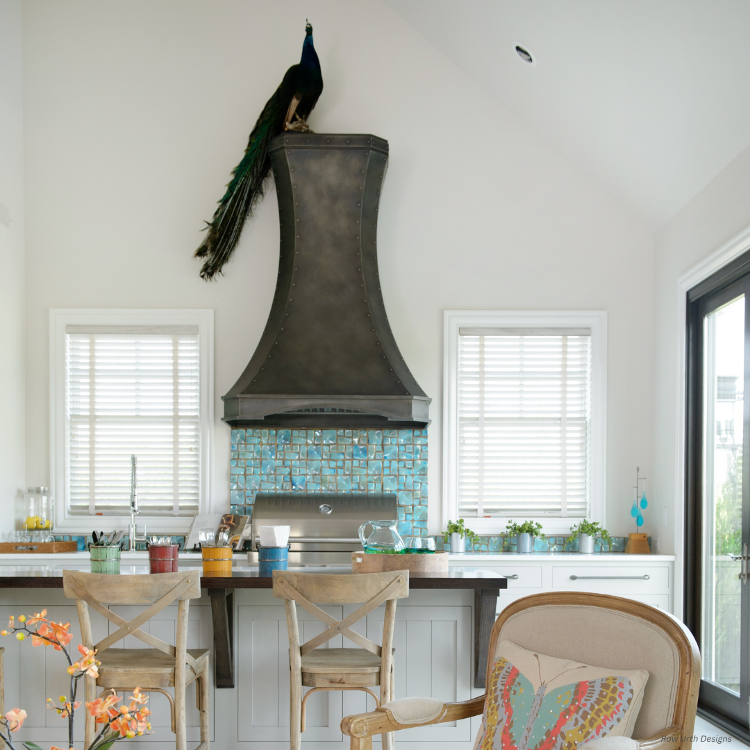 Durango gallery1 Durango gallery1 kitchen features a turquoise tile backsplash, two wooden barstools at an island, and a black range hood topped by a peacock sculpture, with sunlight flooding in through two windows with blinds.