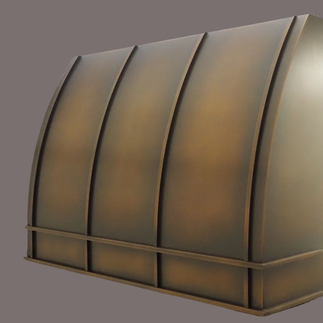 The Foundry 1 features a large, curved metal design with a bronze finish and vertical ridges, displayed against a plain gray background.