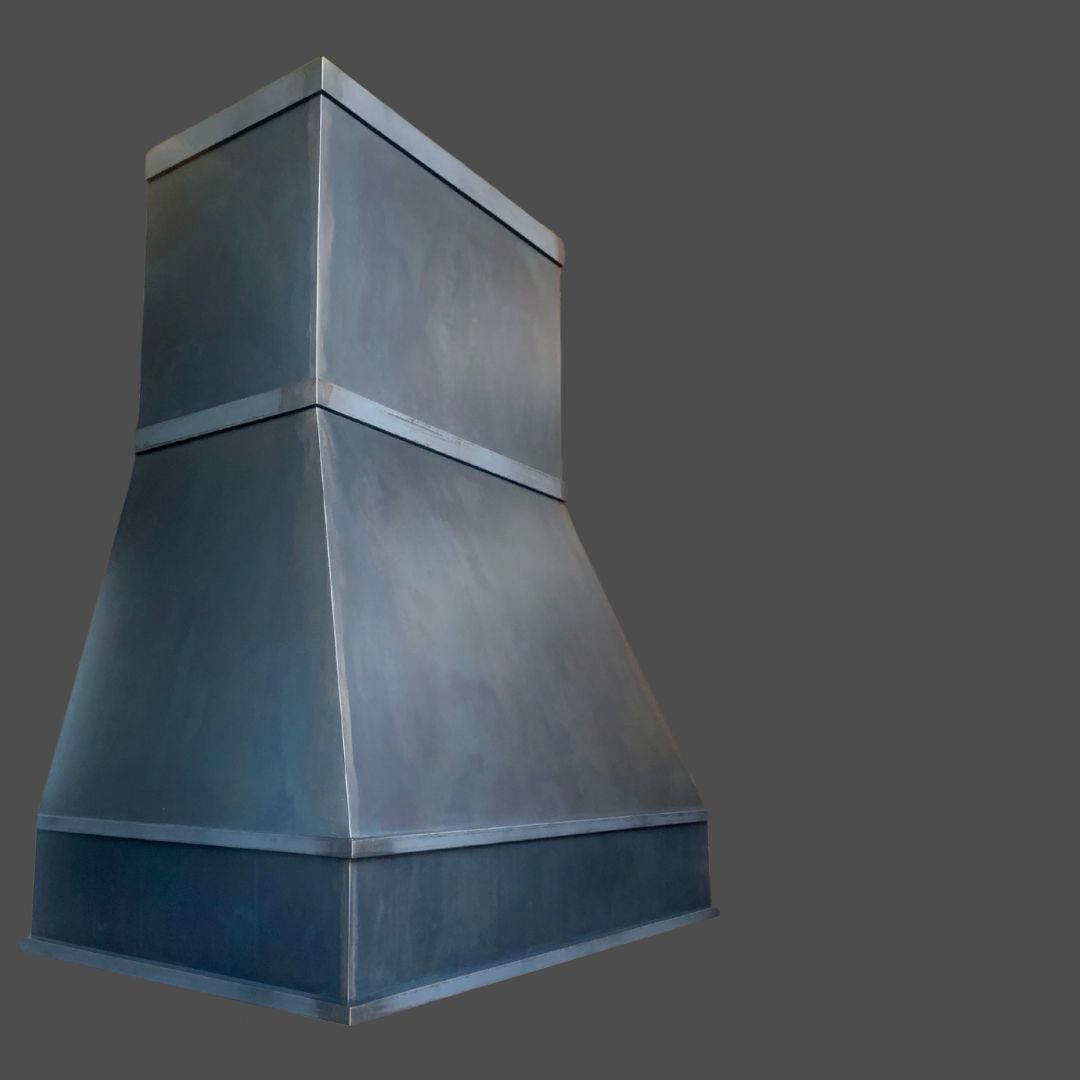 The Gunmetal 1 is a large, industrial-style range hood with an angular, metallic design, shown against a plain gray background.