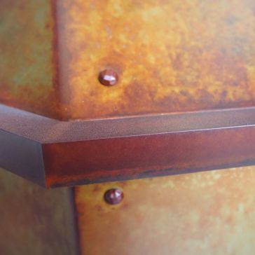 Leathered 6719 Close-up of Leathered 6719, highlighting its textured, weathered surface with visible bolts and an angular edge in orange and brown tones.
