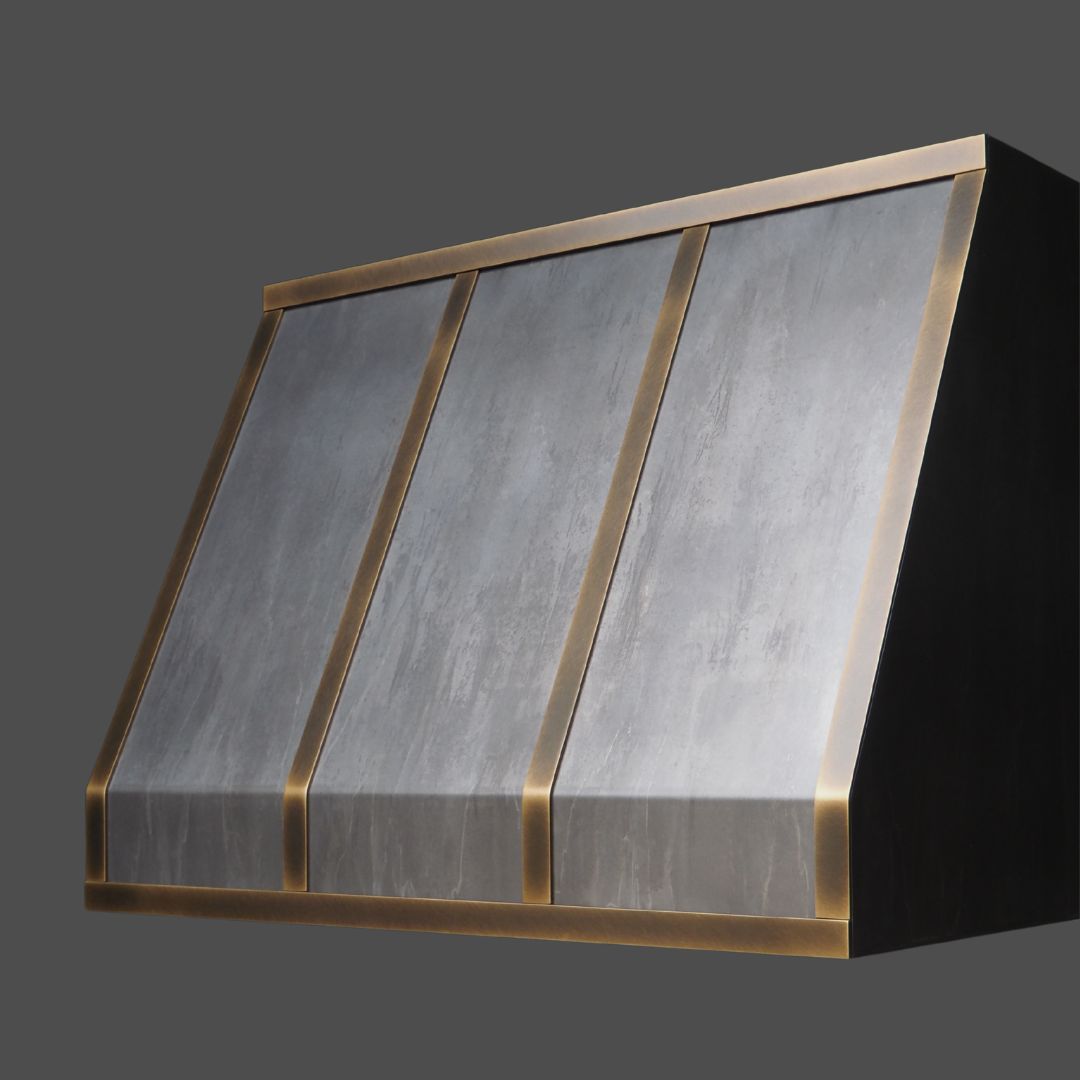 Light Washed 2 The Light Washed 2 is a modern kitchen range hood featuring a sloped, three-panel design in brushed metal with gold trim, shown against a plain dark gray background.