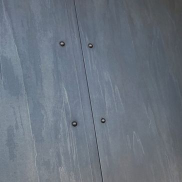 Light Washed 5821 A close-up of the Light Washed 5821 gray surface shows a vertical seam with four evenly spaced round bolts. Subtle streaks and textures give the metal or concrete wall a slightly worn appearance.