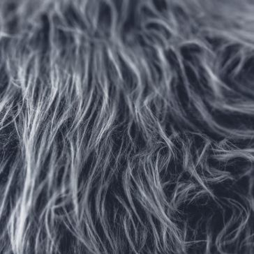 Light Washed 6619 Close-up of Light Washed 6619 shows long, wavy gray and white fibers with a soft, textured look. The strands are tangled and layered, giving the surface a dense and fluffy appearance.