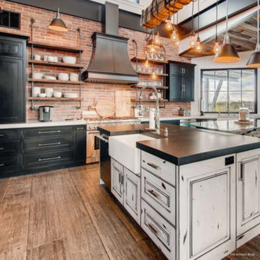 Montrose-tailored-gallery2 The Montrose-tailored-gallery2 features an industrial-style kitchen with exposed brick walls, black cabinets, open shelving, a farmhouse sink set in a distressed white island, modern pendant lights, and large windows for natural light.