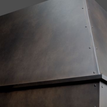 Close-up of the Oil Rubbed 3 shows its dark, matte metal finish with visible rivets along the edges from a slightly angled view, emphasizing its industrial-style construction.