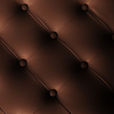 Close-up of Oil Rubbed 5’s brown, tufted leather upholstery featuring button accents at diamond-stitched intersections for a soft, cushioned look.