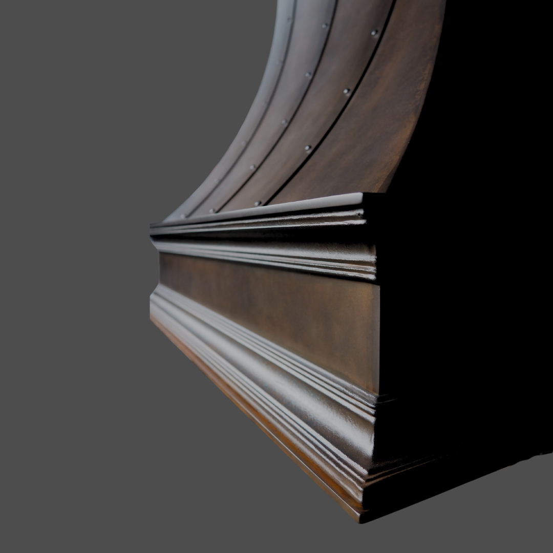 A close-up of Oil Rubbed Iron 2, showcasing its bronze hue, curved architectural form, decorative rivets, and detailed molding against a plain gray background.