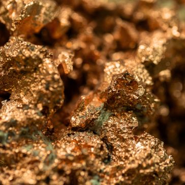 Penny Iron 5609 Close-up of Penny Iron 5609: shiny, textured gold nuggets clustered together, showcasing their metallic surfaces and rough, irregular shapes.