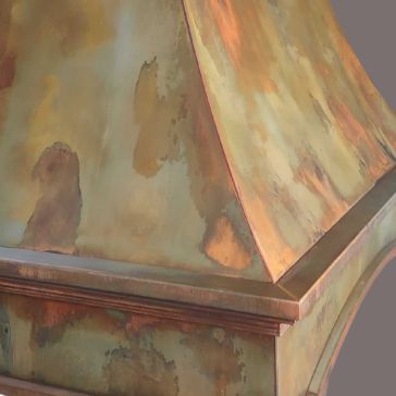 Penny Iron 5697 A close-up view of the Penny Iron 5697 metal surface, featuring a patina finish with brown, green, and orange hues, plus a beveled edge with decorative trim.