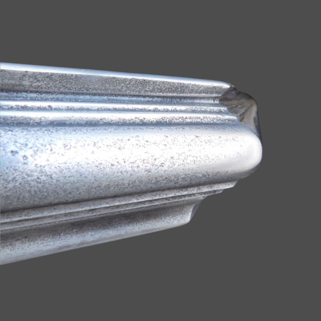 Pewter Cast 1 Close-up of Pewter Cast 1, a metallic silver picture frame molding with a decorative edge, shown against a plain gray background.
