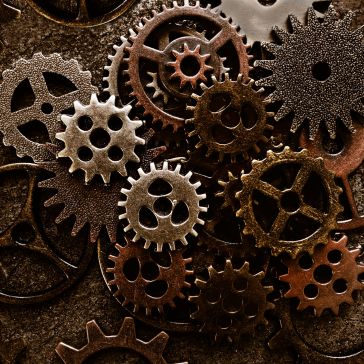 A close-up of interlocking gears in brown, bronze, and gold hues forms a complex pattern, showcasing the detailed design of Rustic Iron 2.