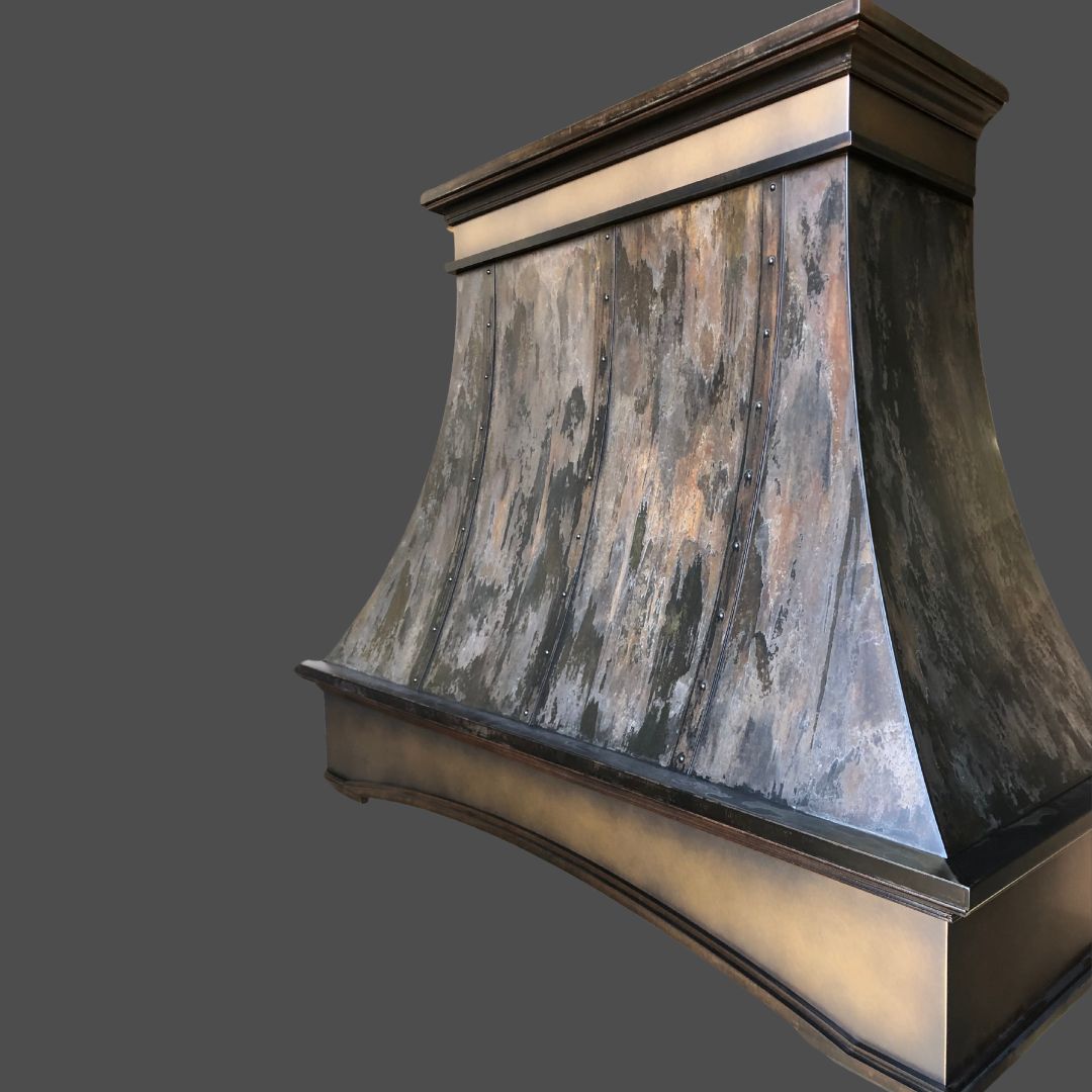 Rustic Reclaimed 2 The Rustic Reclaimed 2 is a large, custom metal range hood featuring a weathered patina finish and curved sides, displayed against a plain gray background.
