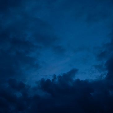 Slate 6893 (2) Dark, moody clouds fill the night sky in Slate 6893 (2), with deep blue tones creating a dramatic and atmospheric scene.