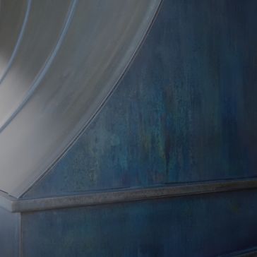 Slate 6919 A close-up of Slate 6919’s metallic blue surface showcases curved ridges with subtle weathered textures and hints of green and grey tones.