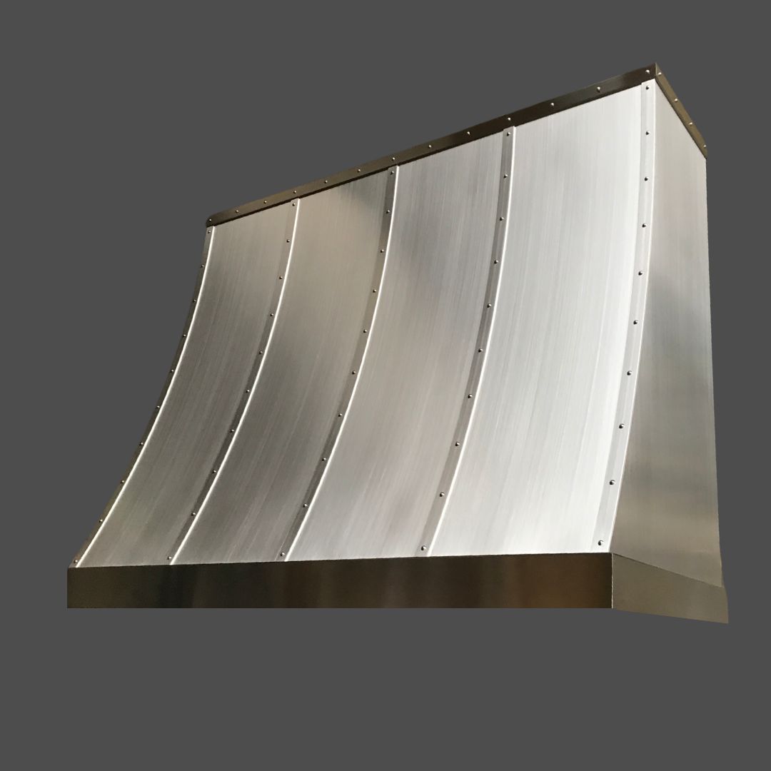The Stainless Grained 3 is a modern kitchen range hood featuring brushed stainless steel, a curved front, and riveted vertical seams, showcased against a plain dark background.