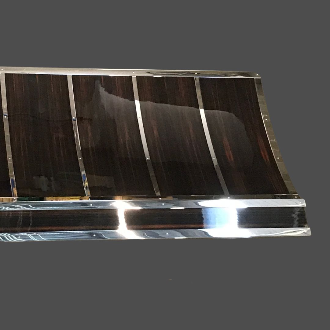 Stainless Polished 1 The Stainless Polished 1 features dark, glossy curved wooden panels with shiny metal accents, displayed against a plain gray background.
