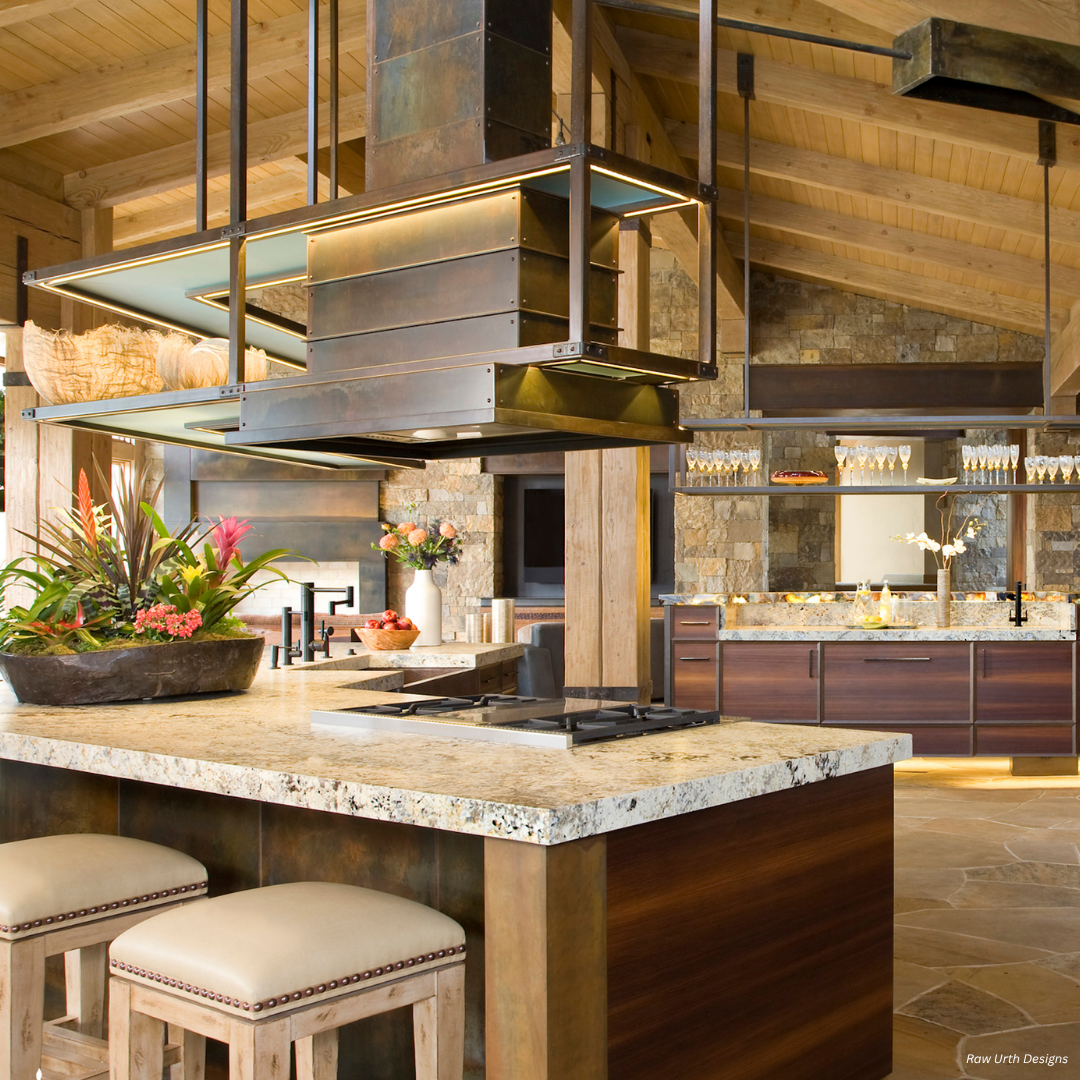 The Wash Park gallery1 features a modern rustic kitchen with a large island, gas cooktop, granite countertops, cushioned stools, open shelving, wooden beams, a decorative plant, and glassware for a bright and inviting space.