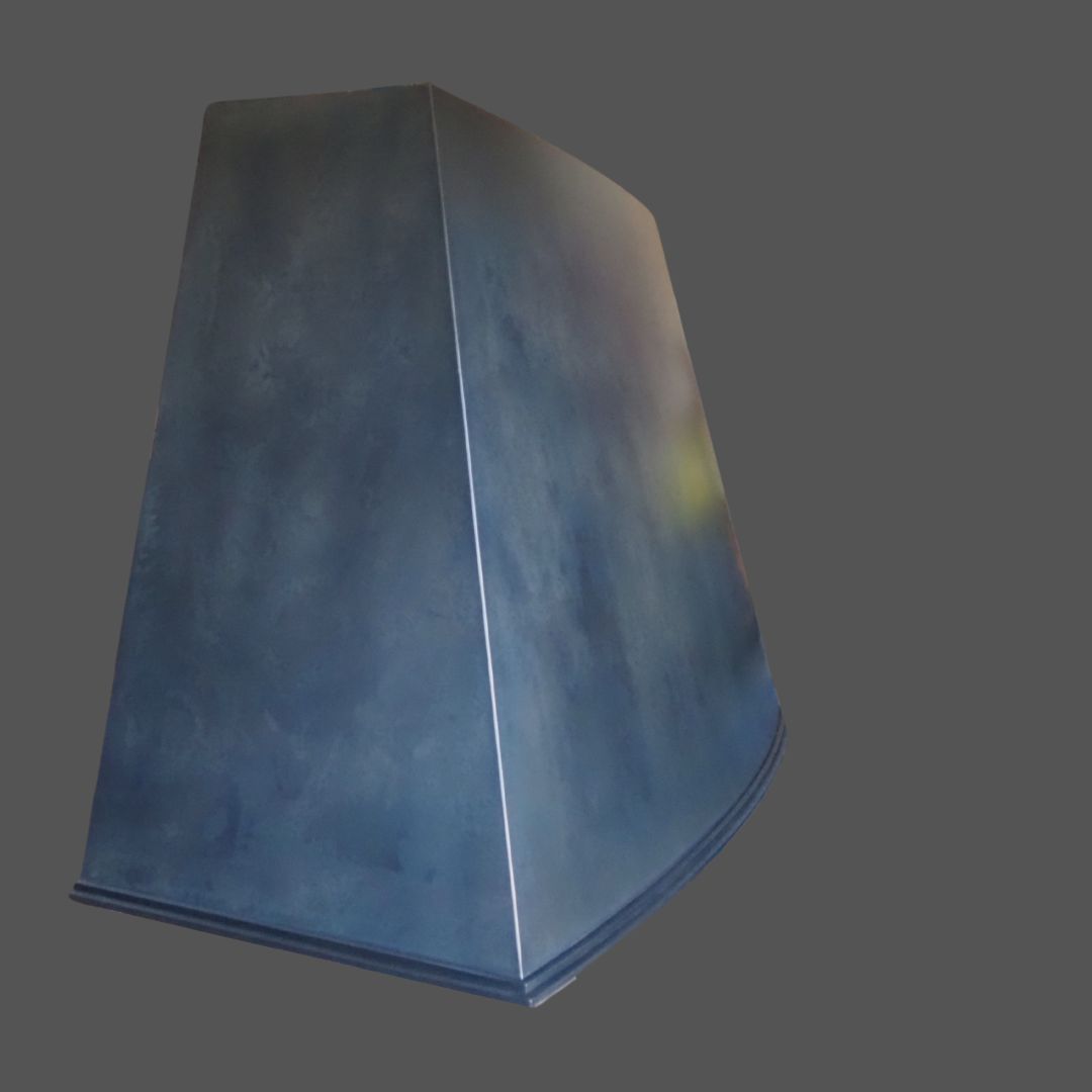 Winter Blue 2 is a large, metallic, dark blue trapezoidal structure with a smooth finish, displayed against a plain gray background.