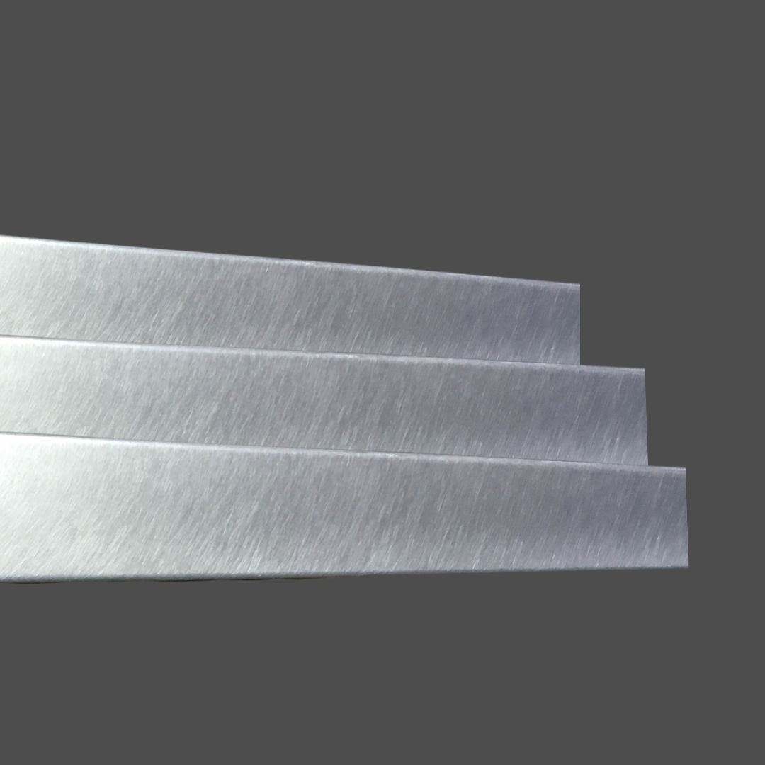 Zinc Burnished 2 Three Zinc Burnished 2 brushed metal sheets are stacked side by side on a dark gray background, each slightly offset above the other to create a stepped appearance.
