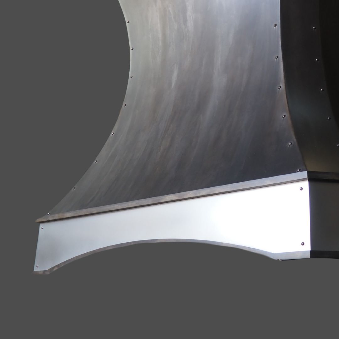 Zinc Burnished 3 Zinc Burnished 3 features a curved metallic structure with a brushed finish and visible rivets, displayed against a plain gray background.