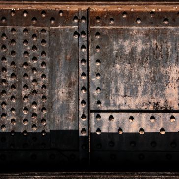 rustic reclaimed 6 Close-up of rustic reclaimed 6: weathered metal surface with rows of rivets, rust, and wear. Vertical and horizontal seams divide the panels, giving an industrial, textured look.