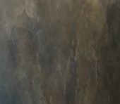 A close-up of Dark Washed, a textured surface with various shades of gray and brown, showcasing uneven patterns and subtle color variations.